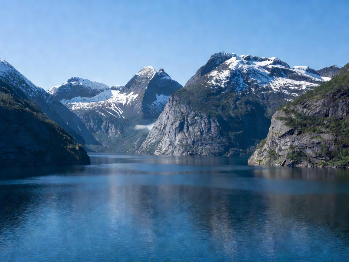 Norwegian fjord with deep blue water and mountain peaks